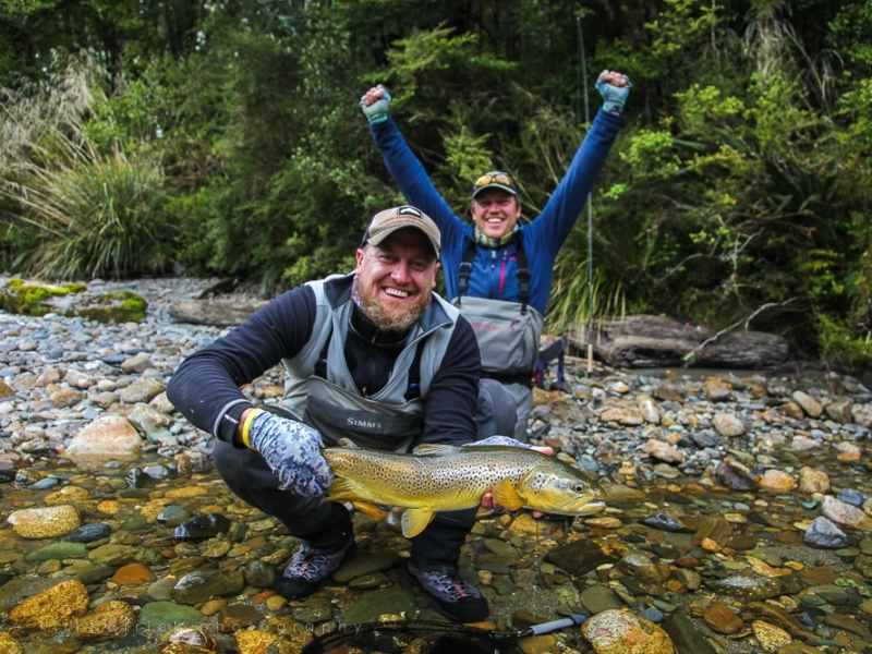 Brothers on the river celebrating catch of fish